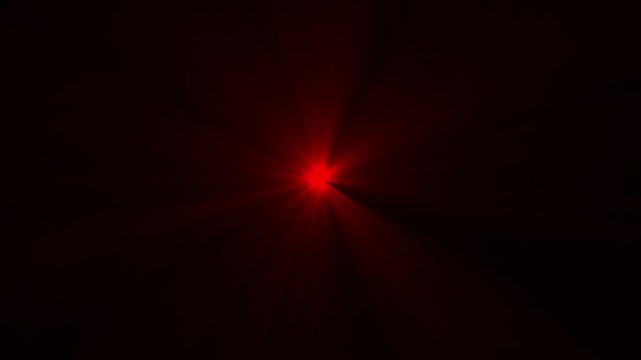 A vibrant red starburst illuminates a dark background radiating energy with intense bright beams high quality