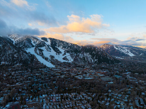Aspen Mountain aerial hyperlapse view at sunrise with scattered clouds overhead