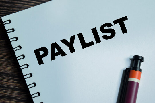 Concept of paylist write on book isolated on Wooden Table. For people to be paid