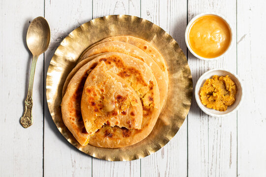 Traditional puran poli, soft Indian sweet flatbread stuffed with jaggery and lentils, aromatic, festive delicacy, golden, rich, homemade comfort dessert
