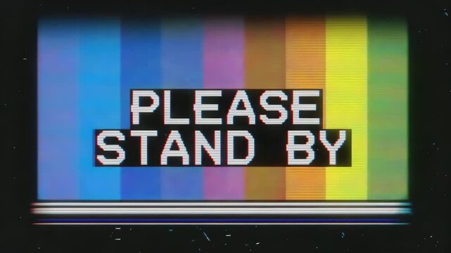 Blurred color background with large bold please stand by black text