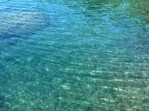 Calm sea ripples water blue surface.