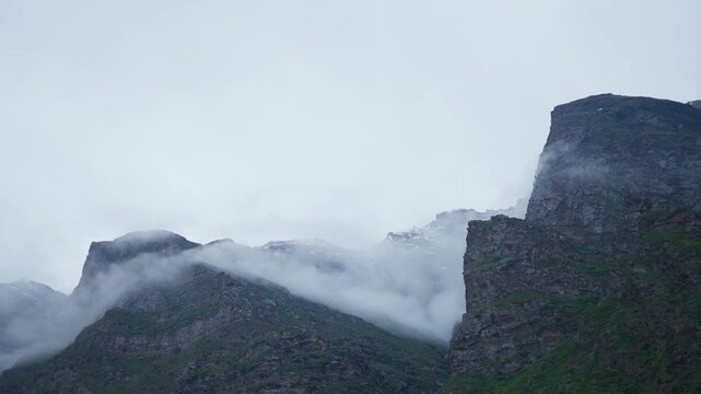 4K Landscape shot of clouds covering the Himalayan mountain peak during the stormy weather in monsoon season as seen from Keylong in Lahaul and Spiti district, Himachal Pradesh, India. Scenic view.