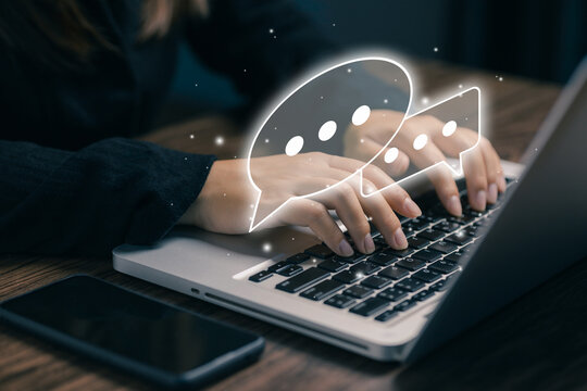 Online communication concept with chat bubbles over laptop, messaging system, customer support, digital interaction, social network, business communication and technology connection.