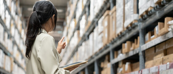 female business owner using digital tablet check amount of stock product inventory on shelf at distribution warehouse factory.logistic business ship and delivery, inventory flow, professional.