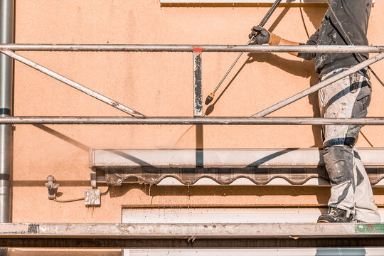 Power washing dirty house siding, a high pressure water jet cleaning
