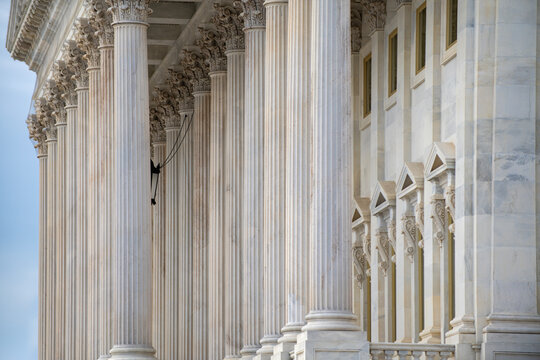 Columns stone architectural perspective symmetry. Columns marble fluted repetition. Columns decorative capitals carved detail. Columns classical facade.