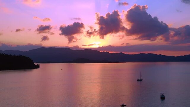 Traditional bancas in Port Barton bay during sunset. Magic aerial view drone