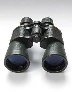 Close-up of Black Binoculars on White Background for Bird Watching and Outdoor Activities.