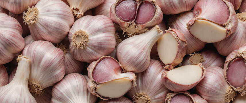 Fresh peeled garlic cloves as background, closeup