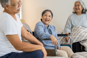Obraz premium Happy elderly asian group smiling laughing together enjoying conversation sitting comfortably resting inside retirement facility sharing joyful moment friendship senior lifestyle community