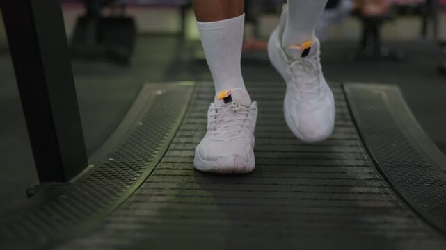 Running on treadmill exercise routine gym fitness indoor close-up health and wellness