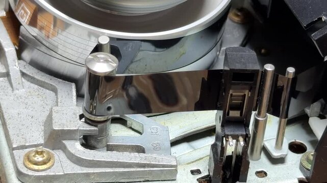 The internal drum and reels rotate during playback, creating a steady mechanical whir. When stopping, the loading mechanism engages to eject the VHS tape, producing rhythmic gear clicks