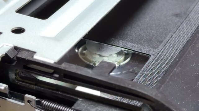 The VCR's internal reels spin during playback, creating a steady whirring sound. Upon stopping, the motorized mechanism engages to eject the cassette, resulting in rhythmic gear clicks