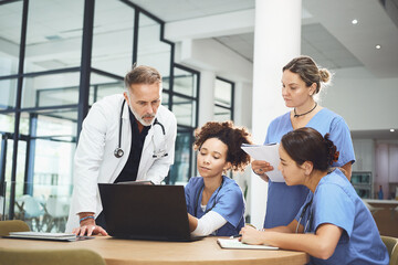 Fototapeta premium People, doctor and nurse with medical discussion on laptop for meeting, planning or procedure in hospital. Group, healthcare workers or team with technology, documents or collaboration for surgery