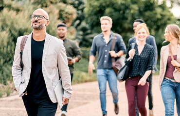 Walking, crowd and business man in city for morning routine, commute and travel to work. Thinking, group and people with confidence, pride and happy for job opportunity, career and growth in town © peopleimages.com