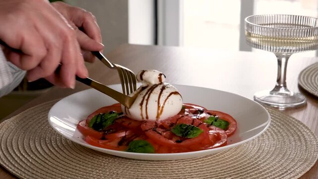 Cutting Burrata Cheese with Creamy Filling Flowing Out Close Up