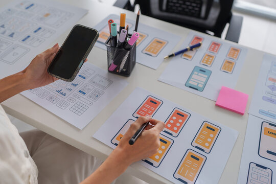 Designer creating mobile application user interface wireframes