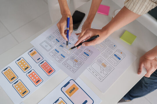 Designers collaborating on mobile application ui ux wireframes