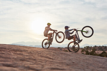 Fototapeta premium Mountain bike, men and journey for fitness, travel and extreme sports with hobby. Trick, healthy people and friends with training, cyclist and adventure to explore, adrenaline and power performance