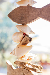 Tiered hanging mobile made of various seashells and carved wooden fish