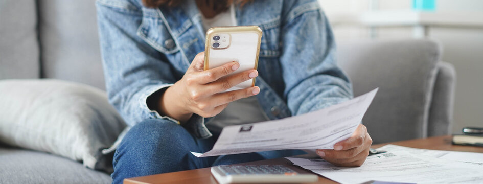 person pay bills via mobile banking at home