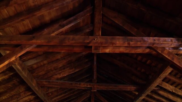 Interior View of Large Wooden Roof Supported by Timber Beams