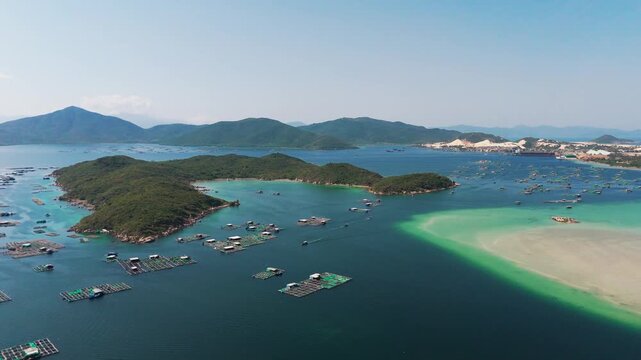 Breathtaking Wide Aerial Drone View of Hon Ong Island Surrounded by Aquaculture Farms, Turquoise Waters and Sandy Spit, Khanh Hoa Province, Central Vietnam, Southeast Asia