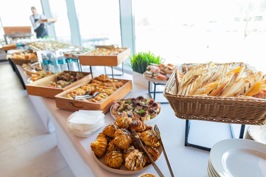 Catering with meats, fruits, cheeses and sandwiches. An assortment of cold cuts and canapes on wooden skewers