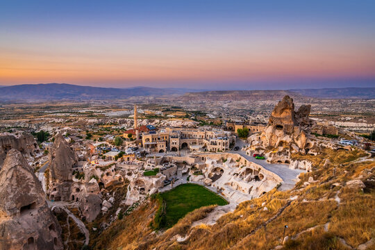 A valley in the mountains of Turkey near Uchisar castle in Cappadocia at sunset.