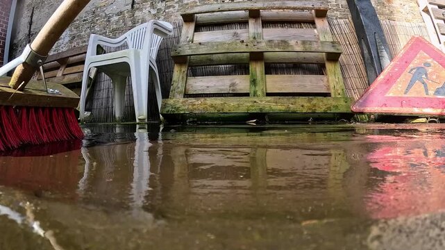 Video cleaning a deck with a deck brush.