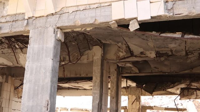 Detailed architectural shot of war-torn concrete structures and building remains in Ma'aloula, Syria