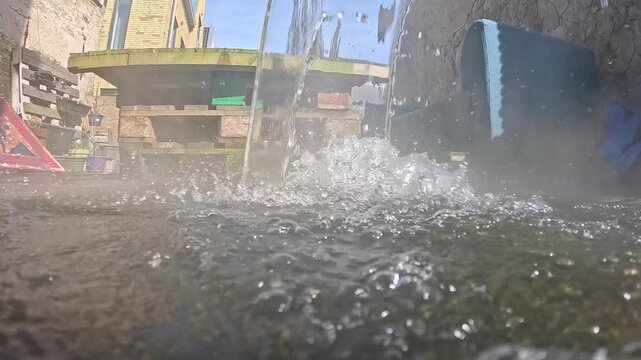 Video cleaning a deck with hot water.