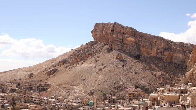 Wide aerial drone vista of the Monastery of Saint Thecla and the ancient village of Ma'aloula in Syria