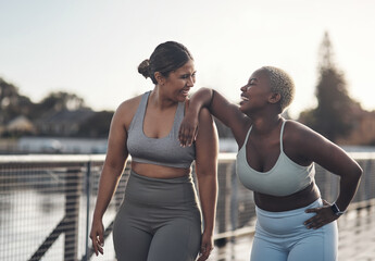 Laugh, fitness and girl friends in city for exercise, health or wellness with challenge together. Happy, sports and female athletes talking for workout on bridge with bonding in morning in town.