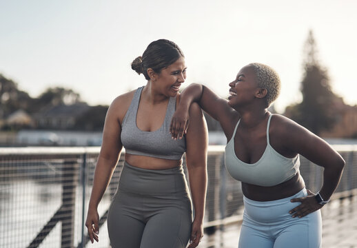 Laugh, fitness and girl friends in city for exercise, health or wellness with challenge together. Happy, sports and female athletes talking for workout on bridge with bonding in morning in town.