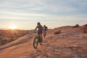 Fototapeta premium Mountain biking, adventure and fitness with men in nature for race, extreme sports and travel. Sky space, training and journey with people or friends on bicycle outdoor cycling, exercise and ride