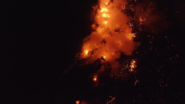 Aerial view of Piton de la Fournaise showing orange lava contrasting with the dark surroundings, Piton de la Fournaise, Saint-Benoit, Reunion.
