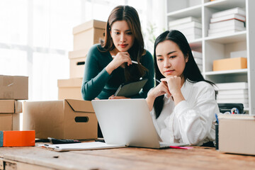 SME startups and small businesses struggling with declining sales are checking inventory, packing...