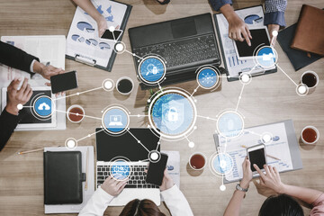 Overhead view of a business team engaged in collaboration, utilizing technology and digital tools,...