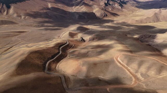 Mountain Switchback Road Across Barren Highlands drone view