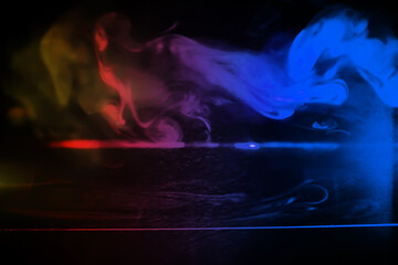 Fototapeta premium colorful smoke on dark background. Color steam on a black background. Red and blue smoke. Copy space.