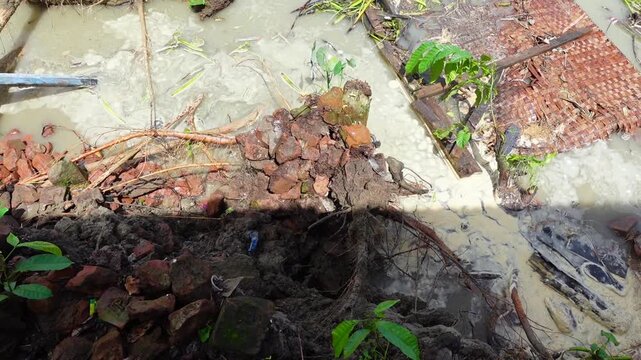 A closeup view of river erosion on a remote riverbank in Dhalchar, Bhola district.