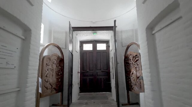 POV Walking Through an Ancient Church Hallway Towards a Dark, Mysterious Door