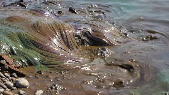 Industrial Pollution Stains Riverbed With Striking Oil and Chemical Seepage Effects