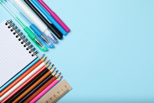 School background. School supplies on the table, stationery, place for text on a blue background
