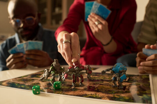 Family playing board game together at home for leisure