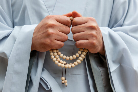 Buddhist monk holding prayer beads in robe at Bulguksa Temple South Korea