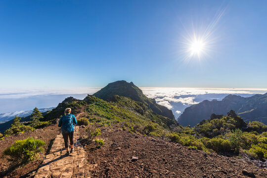 Tourist hiking on sunny day at Pico Ruivo in Madeira Portugal