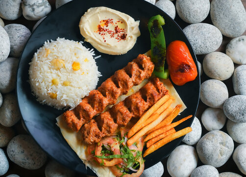 kebab, Chelo Kabab, shishkabob, home-cooked on the grill fire meat beef shish kebab with vegetables, grilled meat skewers, grilled tomatoes and peppers